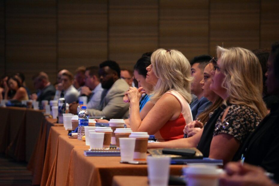 long rows of seminar attendees sitting at a table